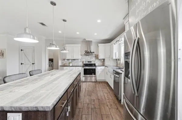 a kitchen with granite countertop a sink and a window