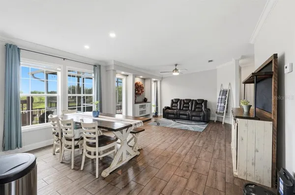 a kitchen with stainless steel appliances granite countertop a refrigerator a stove and a sink with wooden floor