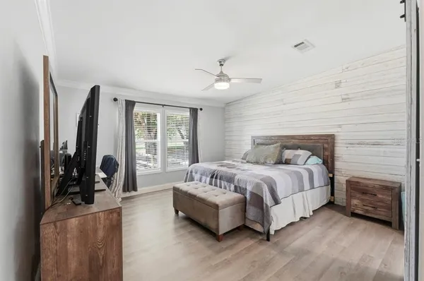 a bedroom with a bed and a flat screen tv