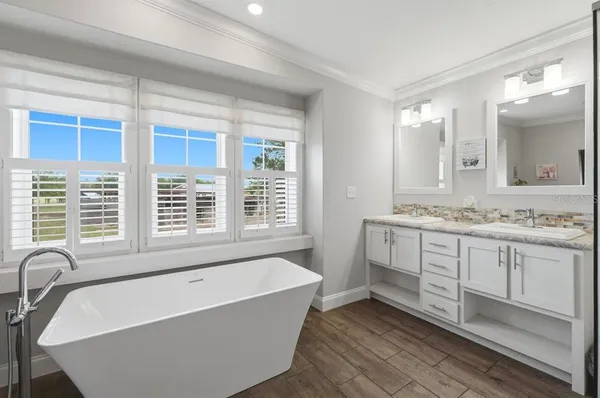 a bathroom with a tub and a shower