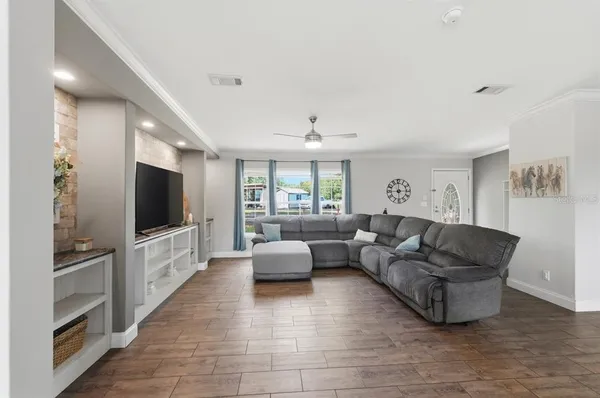 a living room with furniture and wooden floor