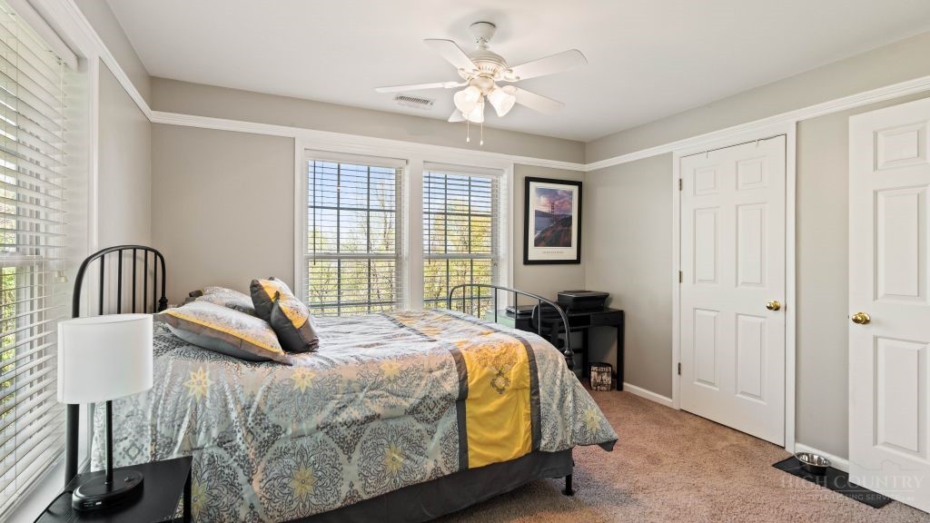 713 Kalmia Lane Boone, NC 28607 - Photo 15 of 50 a bedroom with a bed and a chandelier