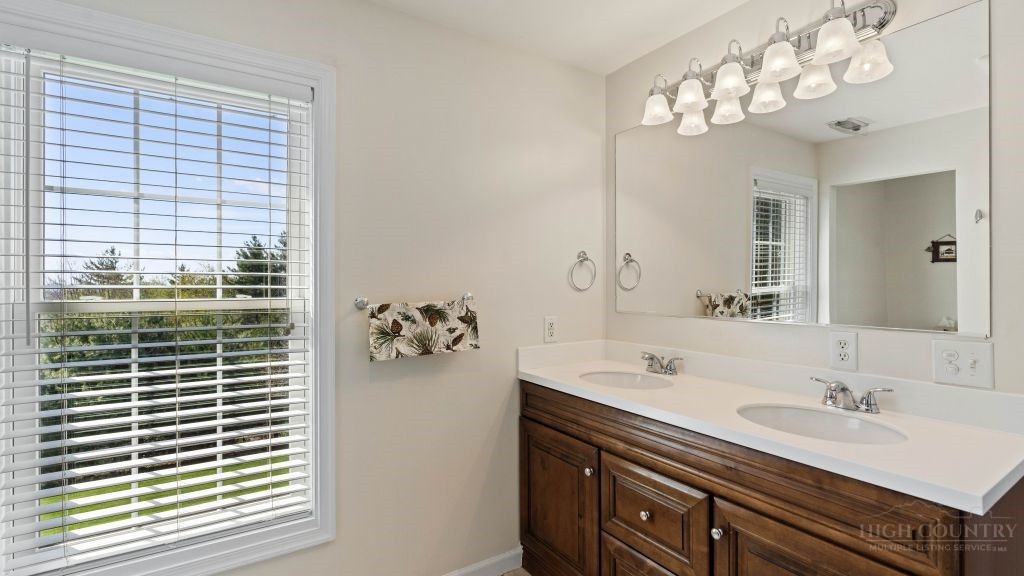 713 Kalmia Lane Boone, NC 28607 - Photo 19 of 50 a bathroom with a sink vanity and a mirror