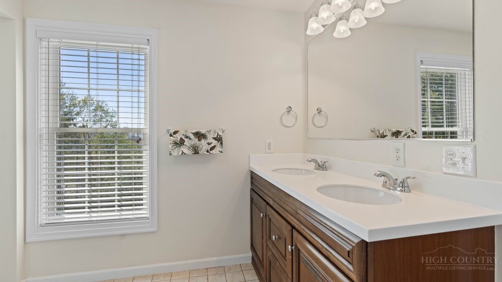 713 Kalmia Lane Boone, NC 28607 - Photo 22 of 50 a bathroom with a sink vanity and a mirror