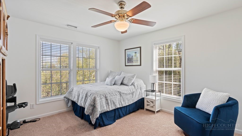 713 Kalmia Lane Boone, NC 28607 - Photo 26 of 50 a bedroom with a bed couch and window