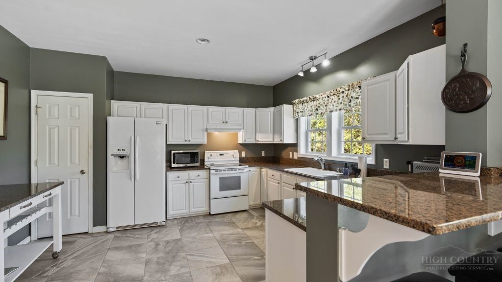 713 Kalmia Lane Boone, NC 28607 - Photo 3 of 50 a kitchen with a sink stove and refrigerator