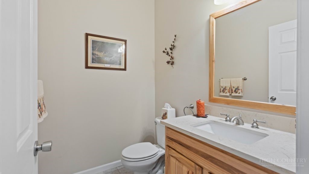 713 Kalmia Lane Boone, NC 28607 - Photo 31 of 50 a bathroom with a granite countertop toilet sink and mirror