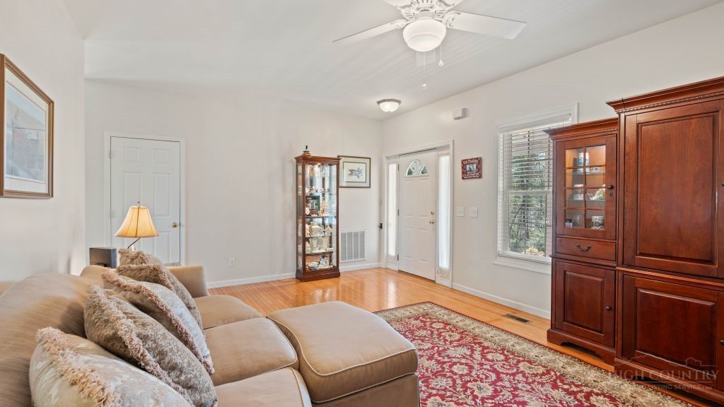713 Kalmia Lane Boone, NC 28607 - Photo 10 of 50 a bedroom with furniture and a chandelier