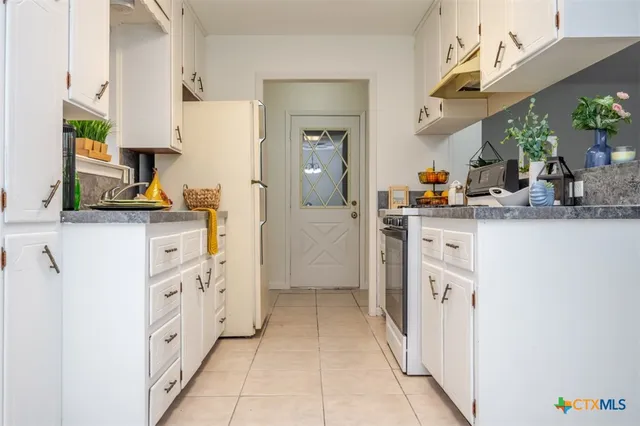 a kitchen with stainless steel appliances a sink stove and cabinets