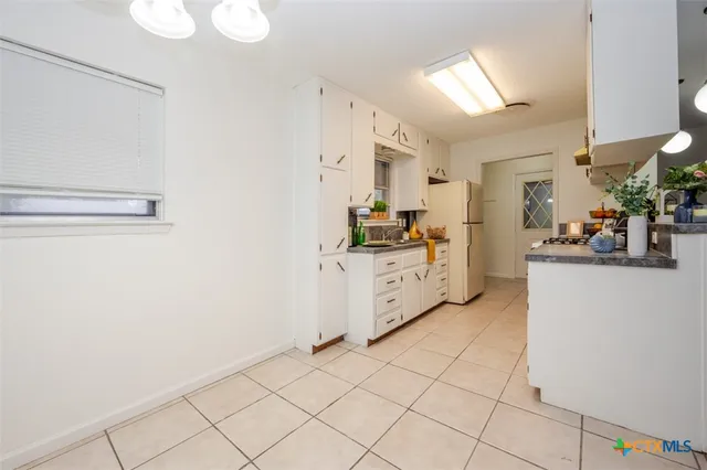 a kitchen with cabinets and white appliances