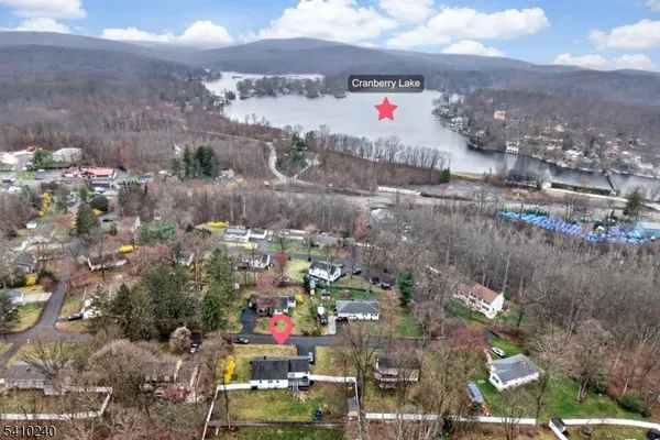 a aerial view of a house with swimming pool and large trees
