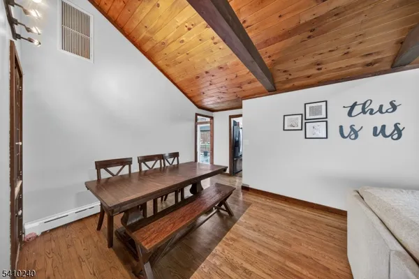 a bedroom with a bed and a flat tv screen on the dresser