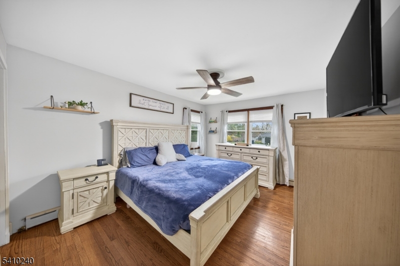 5 Birch Road Andover, NJ 07821 - Photo 24 of 41 a bedroom with a bed and a flat tv screen on the dresser