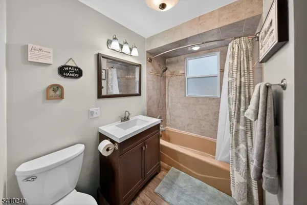 a spacious bedroom with a large bed and a chandelier