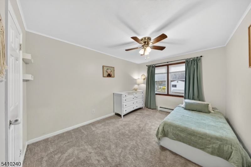 5 Birch Road Andover, NJ 07821 - Photo 34 of 41 a spacious bedroom with a large bed and a chandelier