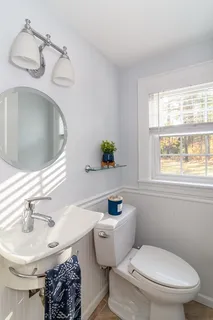 a bathroom with a sink toilet and a mirror