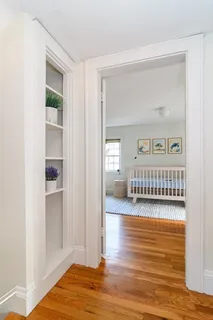 a view of a bedroom with wooden floor