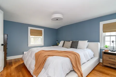 a bedroom with a large bed and a window