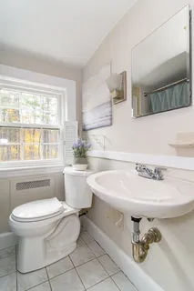 a bathroom with a sink toilet a mirror and bathtub