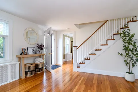 a view of staircase with wooden floor and a potted plant