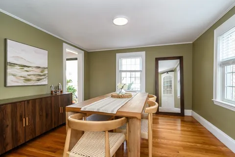 a view of a dining room with furniture and window