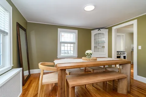 a view of a dining room with furniture and window