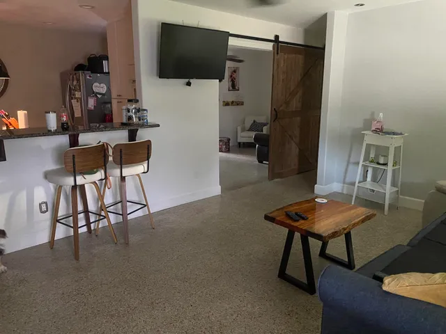 a view of a dining room with furniture and a chandelier fan
