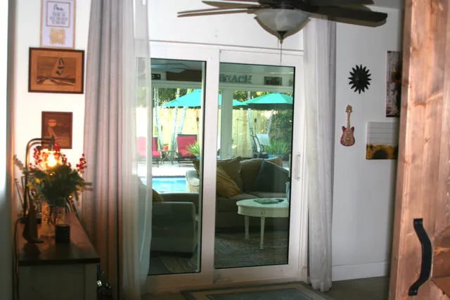 a bedroom with a bed and a flat tv screen next to a window