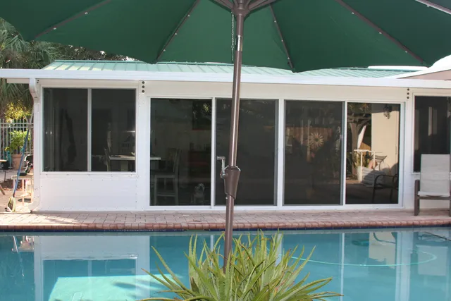 a living room with furniture and a floor to ceiling window
