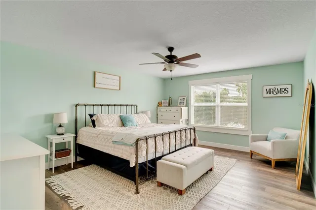 a spacious bedroom with a bed and a window