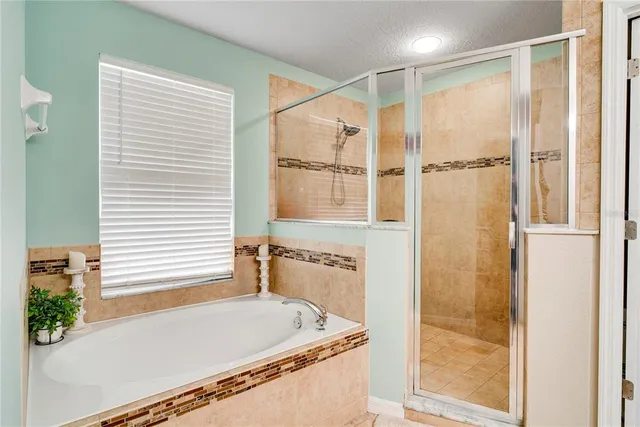a bathroom with a tub and a shower