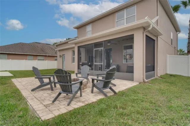 a view of a patio with table and chairs and potted plants