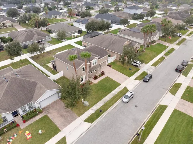 an aerial view of residential houses with outdoor space