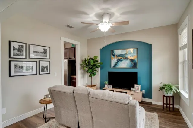 a living room with furniture a fireplace and a flat screen tv