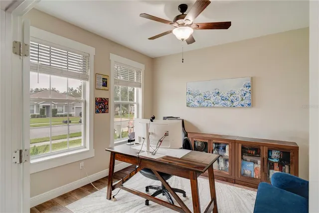 a view of a workspace with furniture and a window