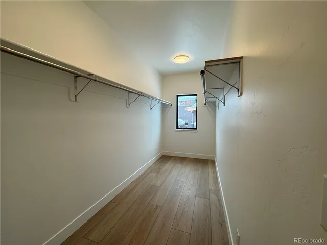 a view of a room with wooden floor and white walls