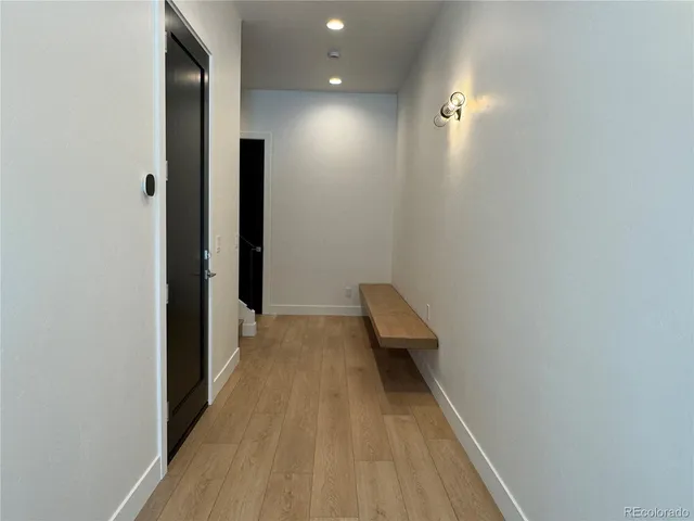 a view of hallway with wooden floor
