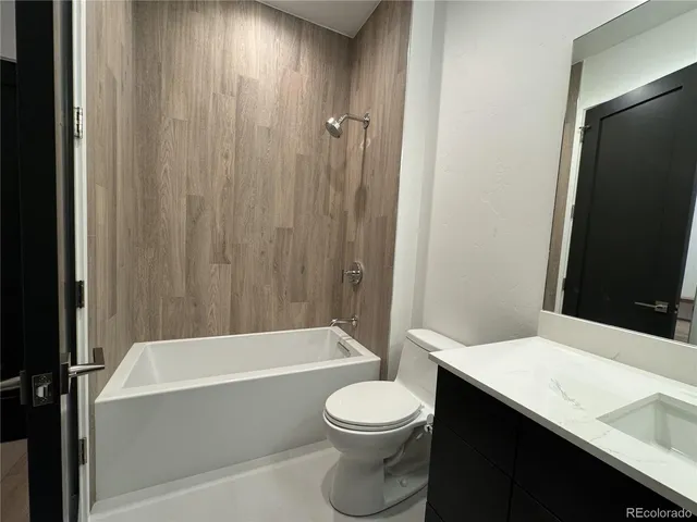 a bathroom with a toilet a sink and bathtub