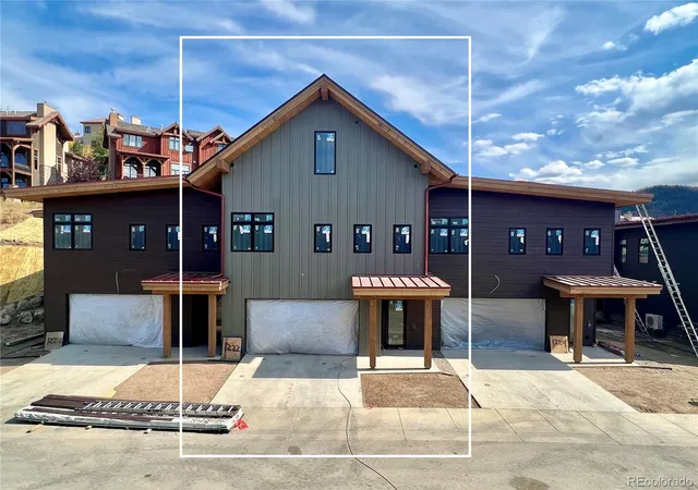 a backyard of a house with barbeque oven table and chairs