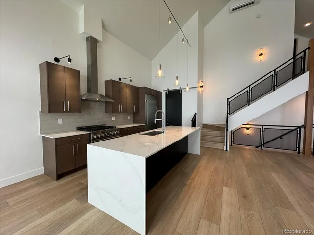 a kitchen with stainless steel appliances a sink and a refrigerator