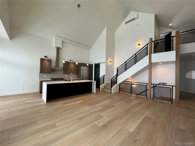 a view of a room with lots of wooden furniture and staircase