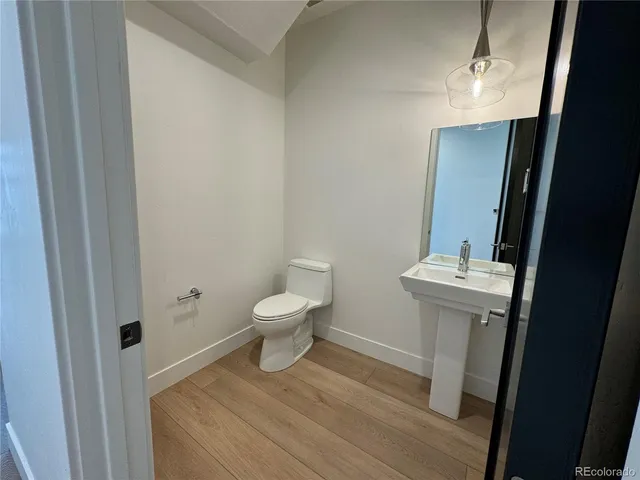 a white toilet sitting next to a bathroom sink