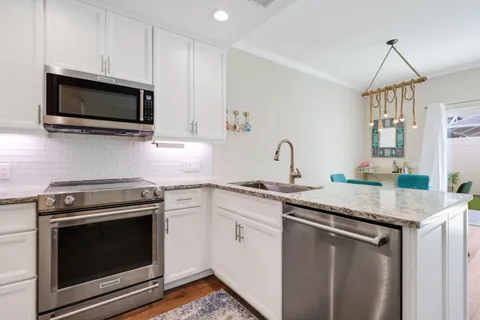 a kitchen with stainless steel appliances and wooden cabinets