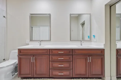 a bathroom with a toilet and a shower