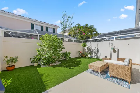 a view of a hallway to potted plants in front of a door