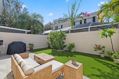 a view of a balcony with wooden floor and potted plants