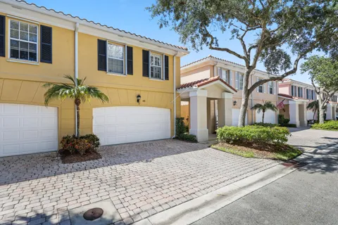 an aerial view of residential houses with outdoor space and swimming pool