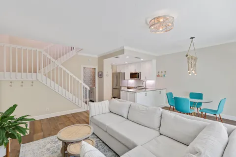 a kitchen with granite countertop cabinets a sink and a refrigerator