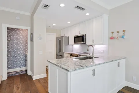 a kitchen with a refrigerator sink and wooden cabinets