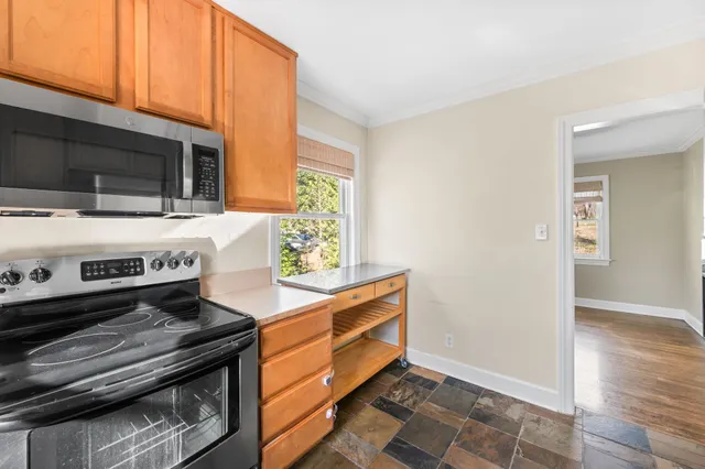 a stove top oven sitting inside of a kitchen